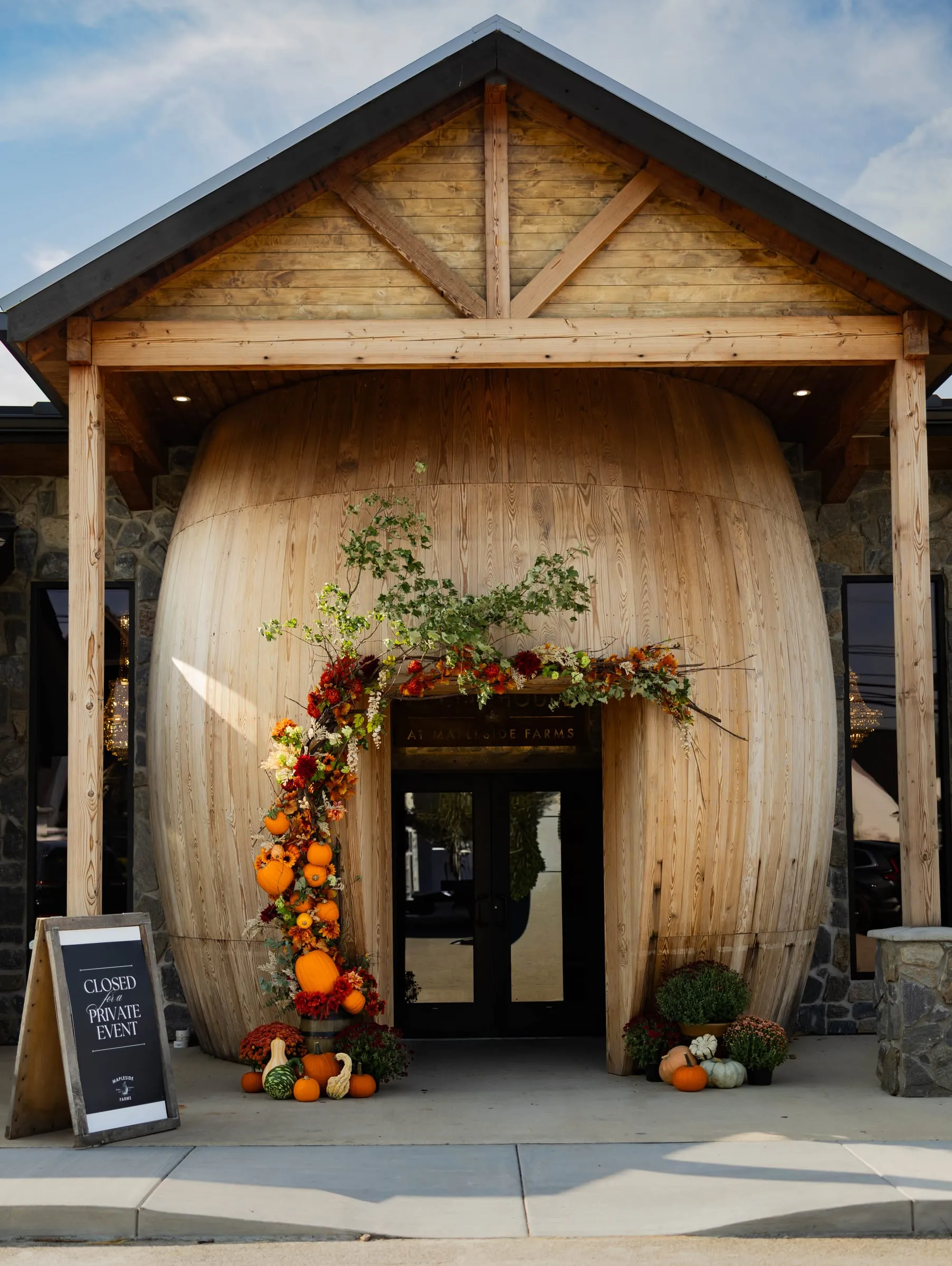 The wine barrel entrance to The Social House, decorated for fall
