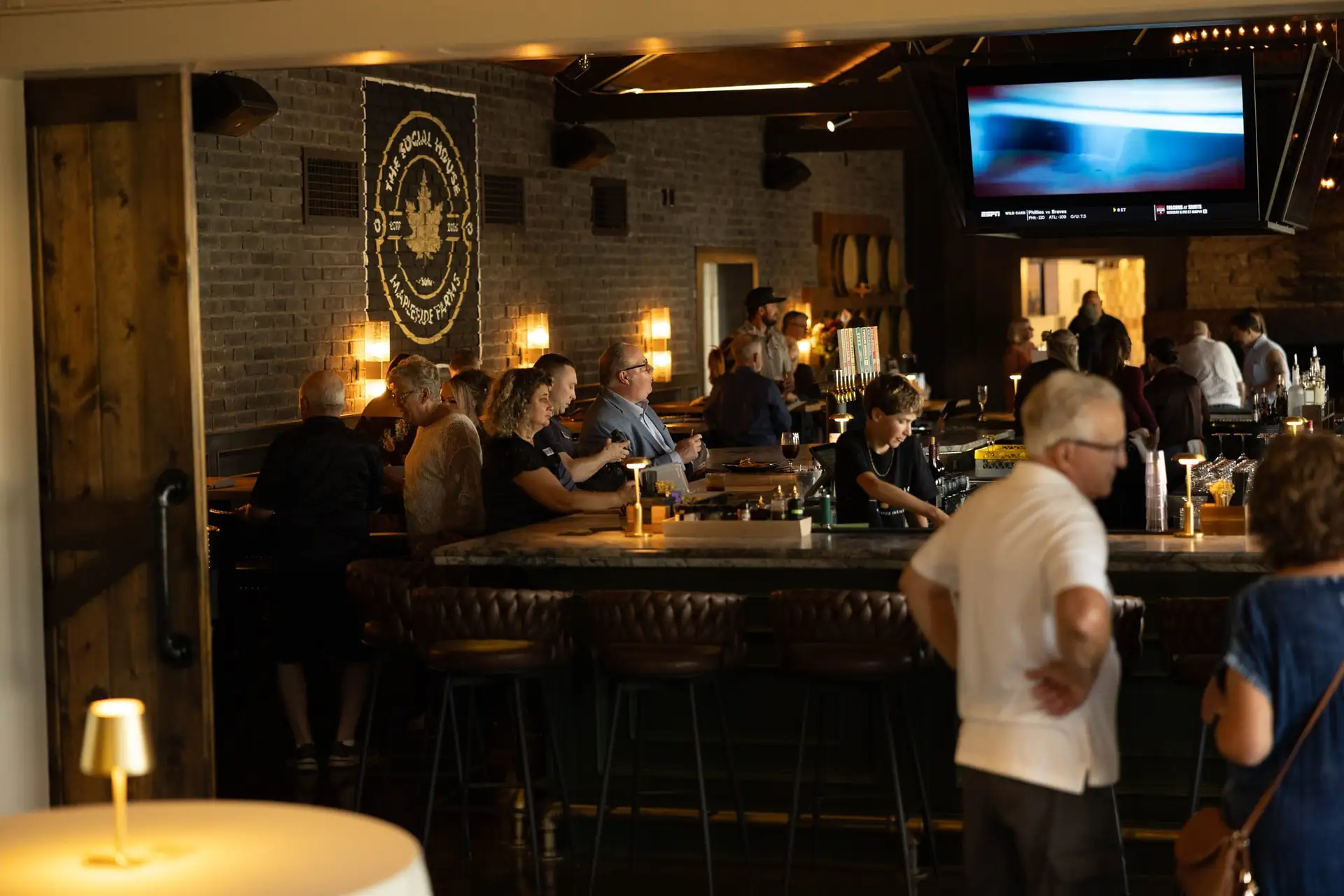 The evening crowd filling The Great Room around the central bar