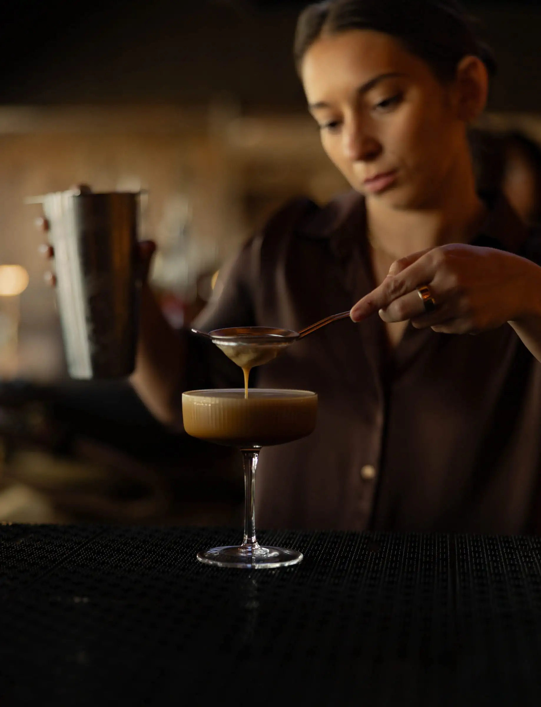 A bartender finishing an espresso martini