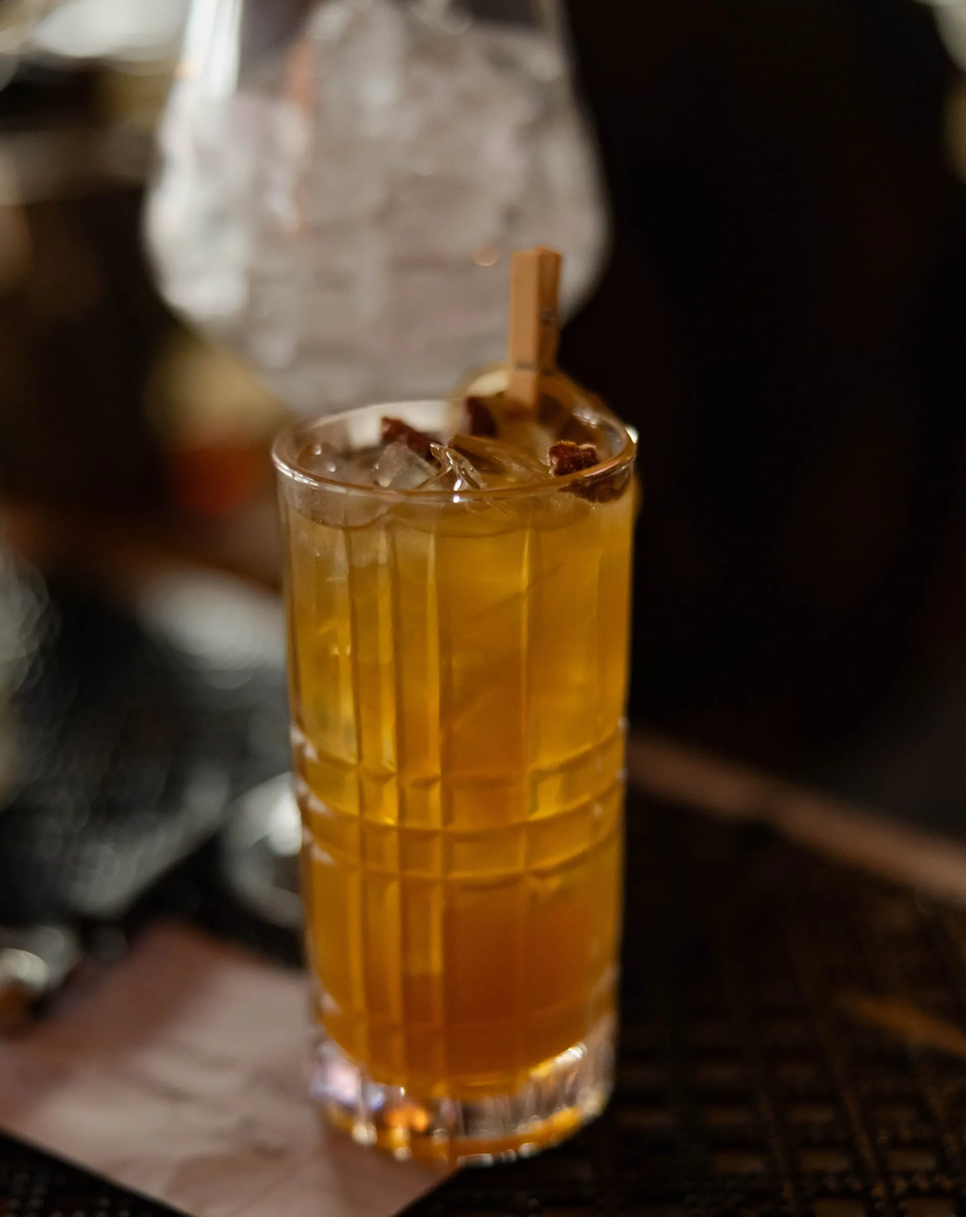 An iced amber cocktail on the bar