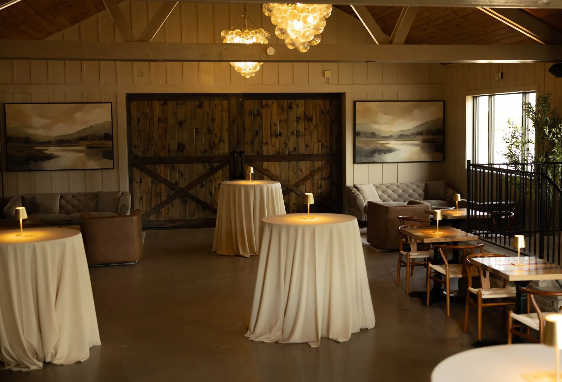 Barn doors, landscape paintings and cocktail tables in The Library