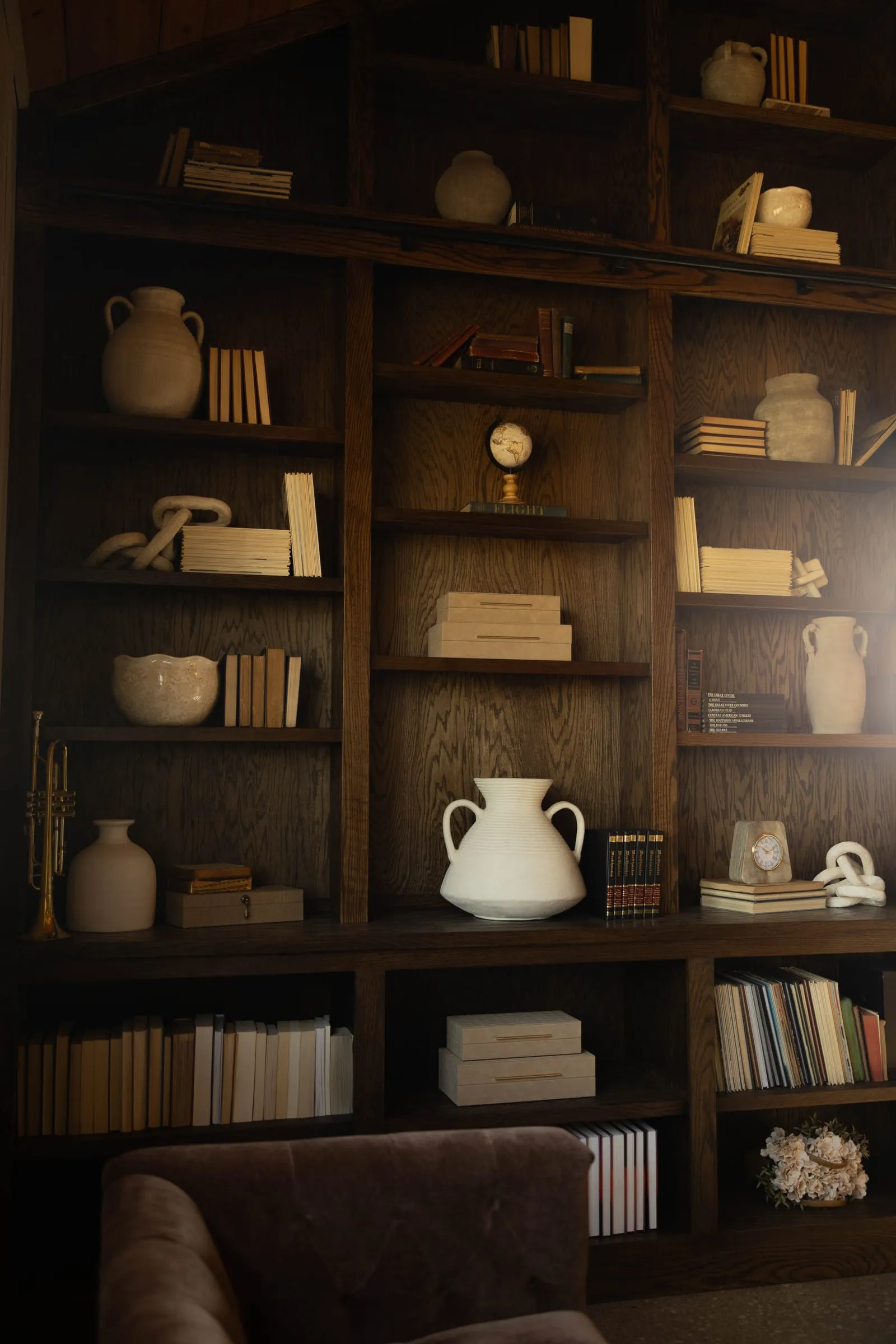 Built-in shelves of pottery and books in The Library