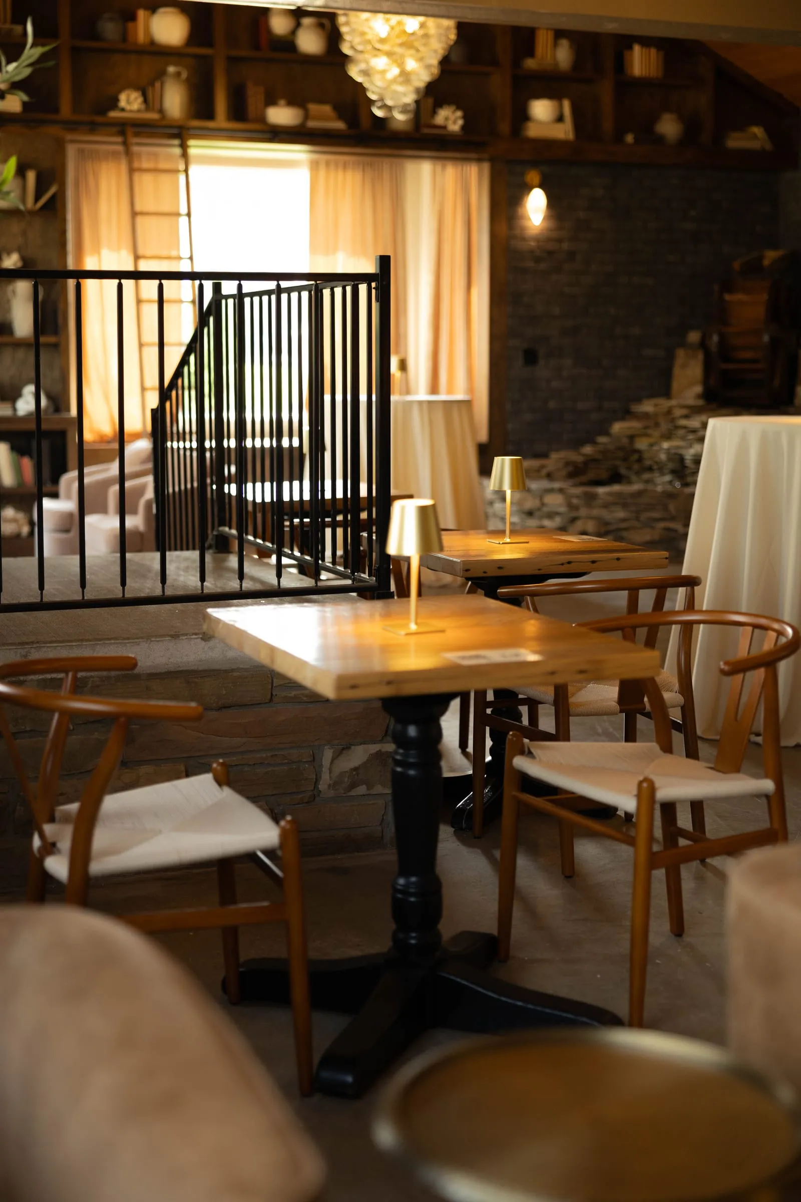 Tables and chairs along the railing in The Library