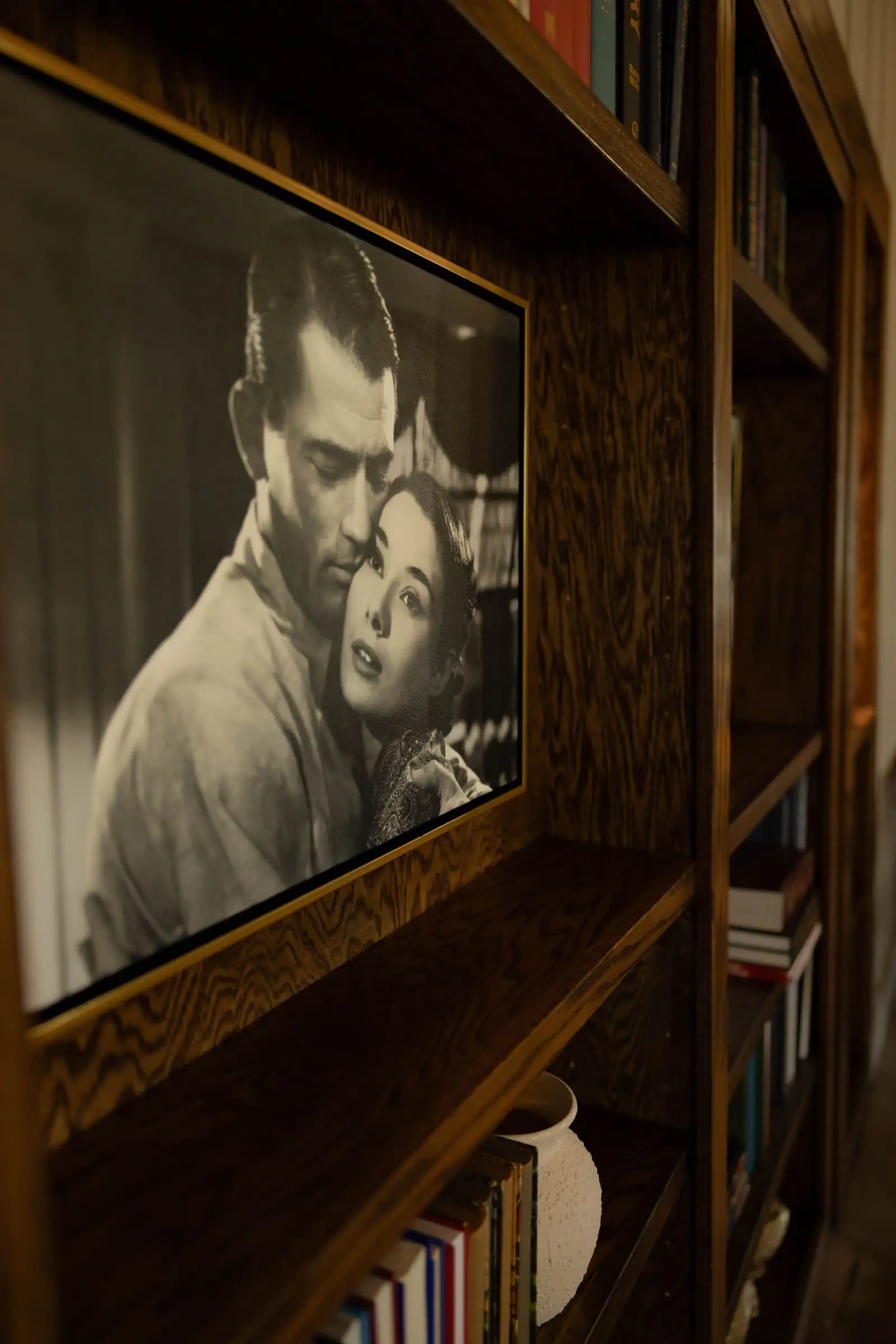 A framed vintage film still among the Library shelves