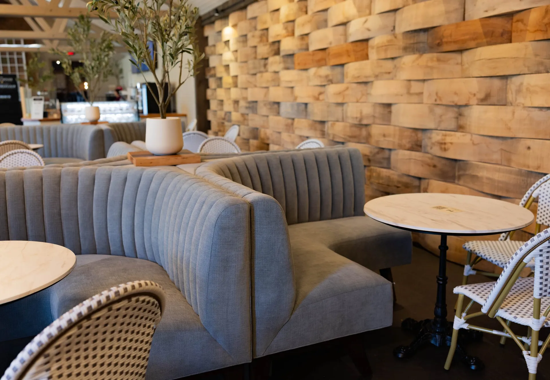 Curved banquettes and bistro tables in The Press